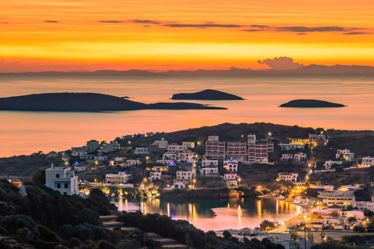 Sonnenuntergang über Batsi, mit den Lichtern der Bucht und kleinen Inseln in der Ferne, Andros