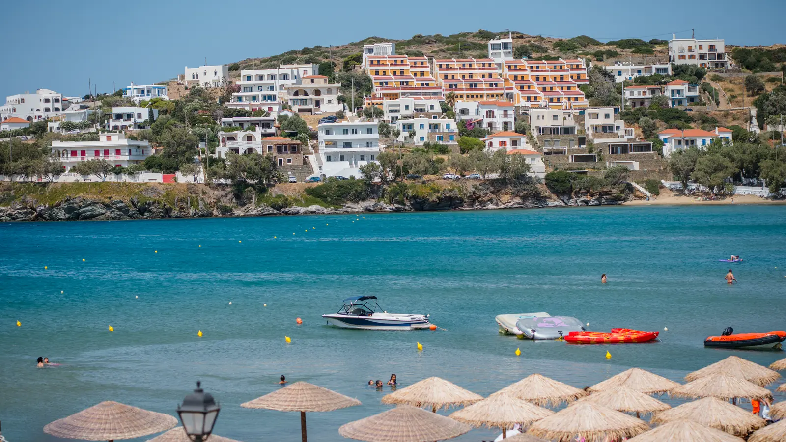 Ο όρμος του Μπατσίου με τις ψάθινες ομπρέλες και τους λουόμενους, θέα από το Bella Vista Design Studios, Άνδρος